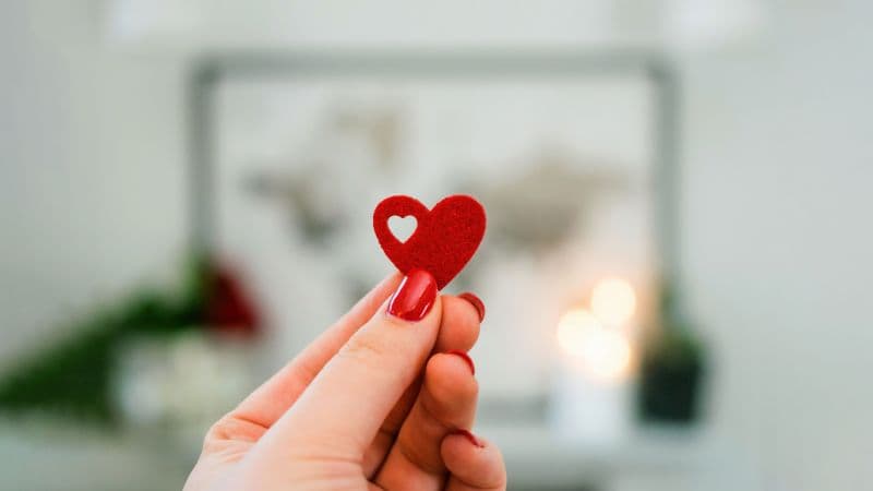 Red heart in Woman's hand Wallpaper