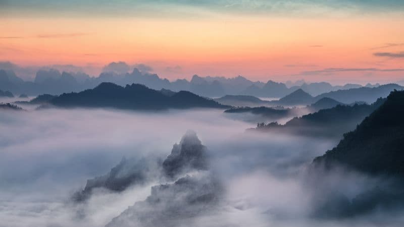 Mountain range Foggy sunset Wallpaper