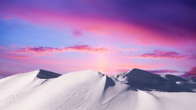 Snowy mountain with a Sunset in the background Wallpaper